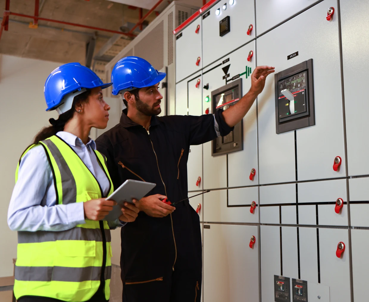 Workers examining electrical equipment